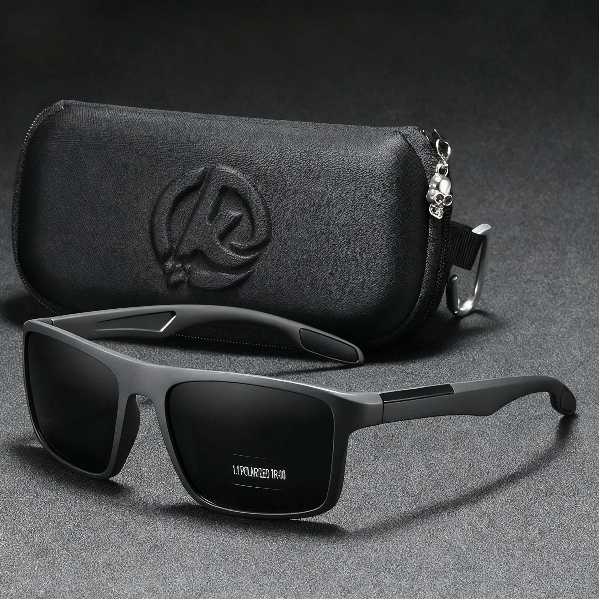 Black sunglasses with a matching case on a gray background