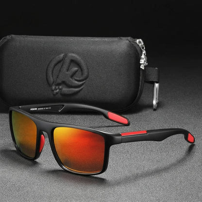 Sunglasses with red mirror lenses and black frame on a gray surface, accompanied by a black case.