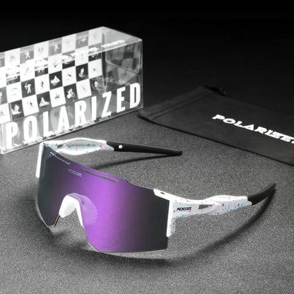 Polarized sunglasses with purple lenses, packaging, and case on a gray surface.