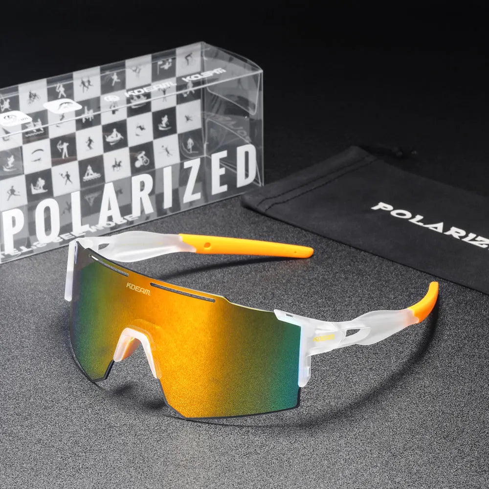 Polarized sunglasses with yellow and green gradient lenses, accompanied by a branded box and pouch on a dark surface.