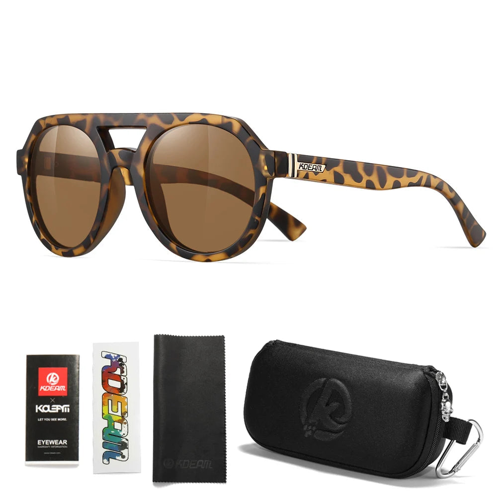 Sunglasses with leopard print frame and brown lenses, accompanied by packaging and cleaning cloth on a white background.