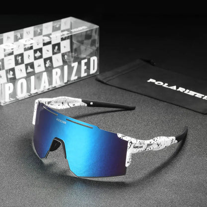 Blue reflective sunglasses with a black and white patterned arm on a gray surface, with 'Polarized' branding visible.