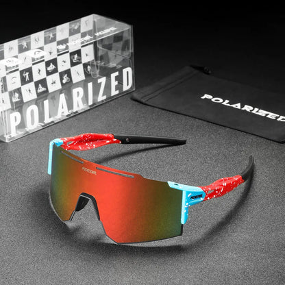 Polarized sunglasses with red and blue frame on a gray surface, accompanied by a branded box and pouch.
